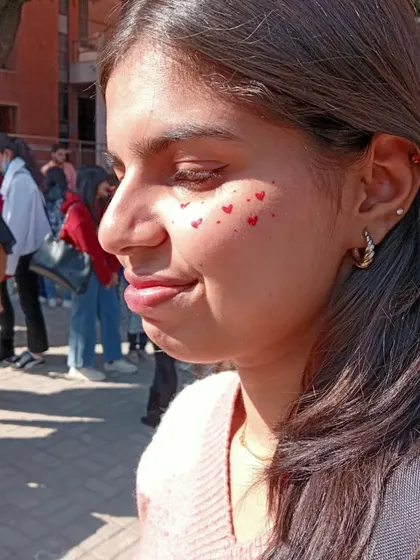 A scattering of tiny red hearts across the cheeks. A simple, sweet, and fun design for any celebration.