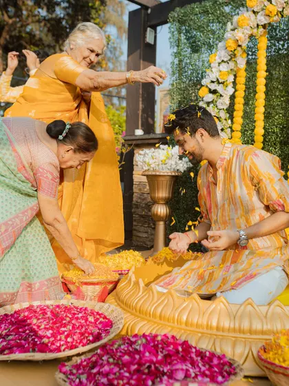 The elders of the family shower the groom with blessings and flower petals. A beautiful moment that shows the importance of family traditions and love.