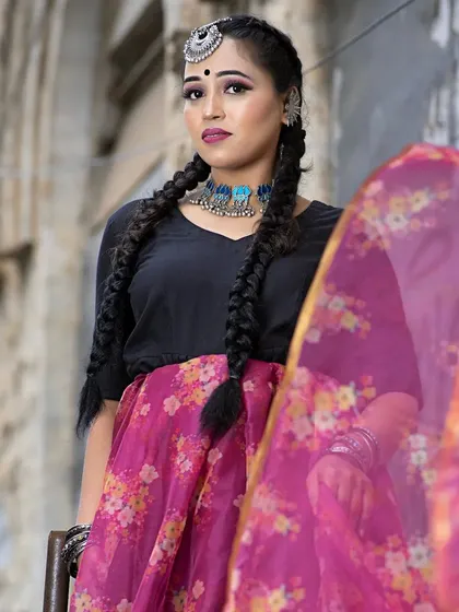 Another angle of this stylish indo-western look. The makeup is kept clean and elegant to balance the statement jewellery and the flowing floral skirt, creating a very fashionable ensemble.