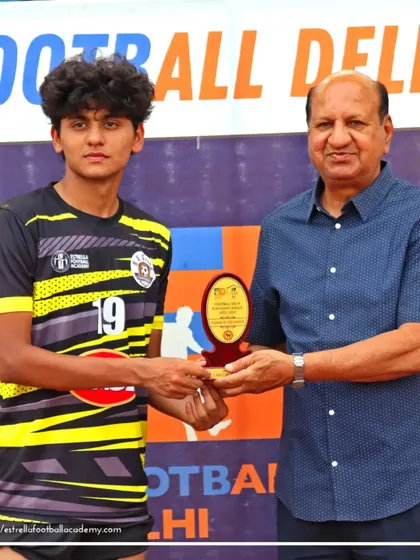 One of our players receiving the "Best Player of the Match" award from a Football Delhi official. This recognition highlights the individual talent we nurture at the academy.
