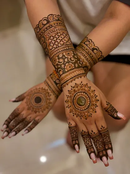 A crossed-hands pose showing the full Diwali mehendi design.