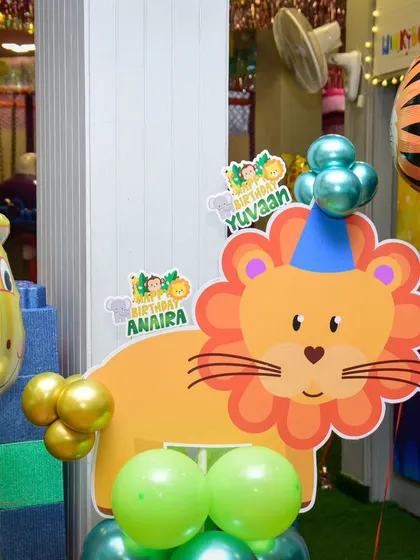 A cute lion cutout adds a friendly roar to our jungle-themed party decor.