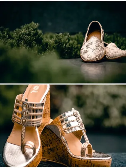 A detailed shot of the wedding footwear, showcasing the groom's traditional mojris and the bride's elegant wedge sandals.