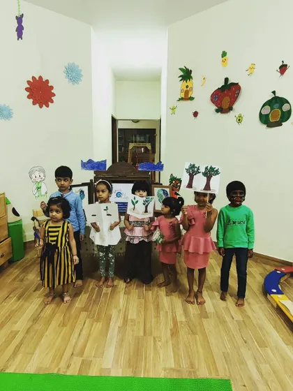 A group of our youngest participants holding up the character props they made. This craft activity for preschoolers helps reinforce the story's characters and gives them something to play with at home.