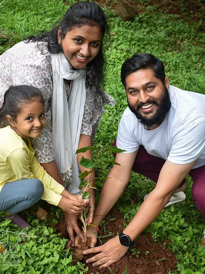 A family participates together in a tree planting event. We encourage people of all ages to engage in seva, making it a meaningful experience for everyone.