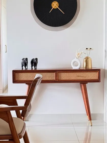 A story by the dining area. This mid-century modern console table with wicker drawers adds style and storage to the space.