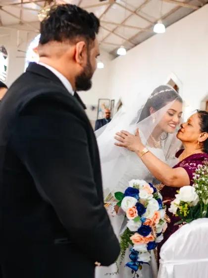 A mother's gentle kiss as she hands her daughter over to the groom at the altar. A poignant and beautiful start to the wedding ceremony.