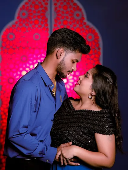 An intimate close-up shot. The focus is on their connection, and their simple outfits complement the mood perfectly.