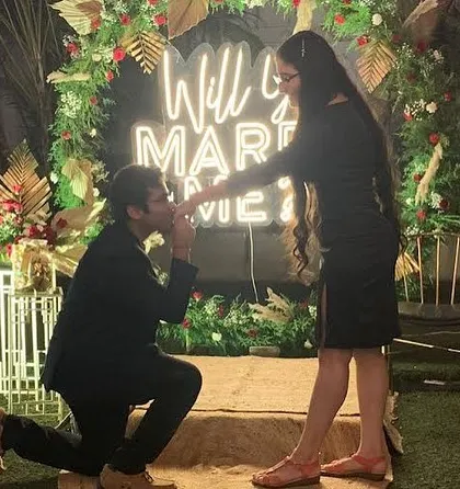 A picture-perfect proposal in front of a custom "Will You Marry Me" neon sign, framed by a beautiful floral arch. I ensure every detail is ready for that unforgettable question.