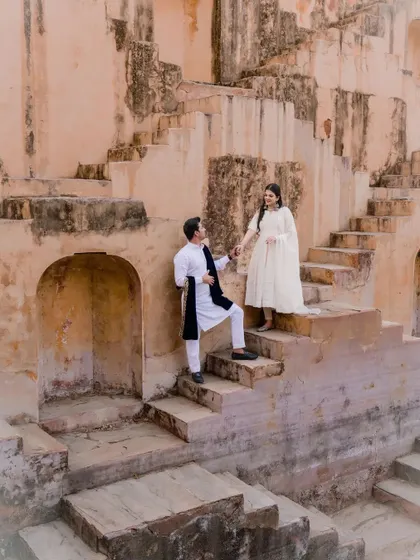 Our pre-wedding shoots are about telling your story in a beautiful setting. This candid moment, captured at a historic step-well, shows our approach to creating natural, romantic images that reflect your personality against a stunning architectural backdrop.