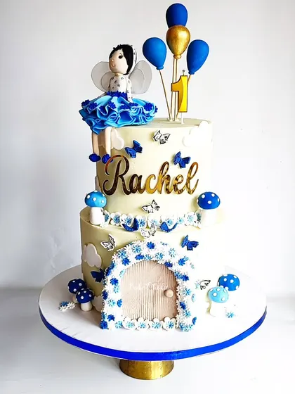 A studio shot of the fairy-themed cake for Rachel's first birthday. The blue and white color scheme is a lovely alternative to the usual pink.