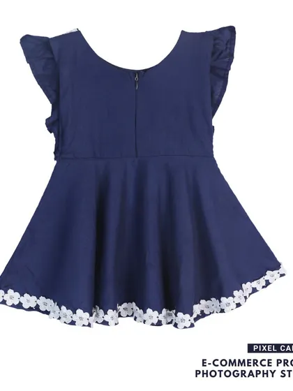 The back view of a navy blue baby frock, showing the zipper and fit.