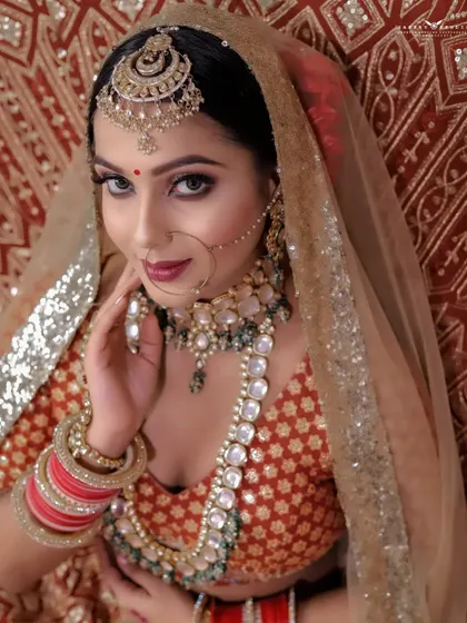 A captivating close-up portrait. The bride's direct gaze and the slight tilt of her head create an engaging and confident image, showcasing her beautiful features.