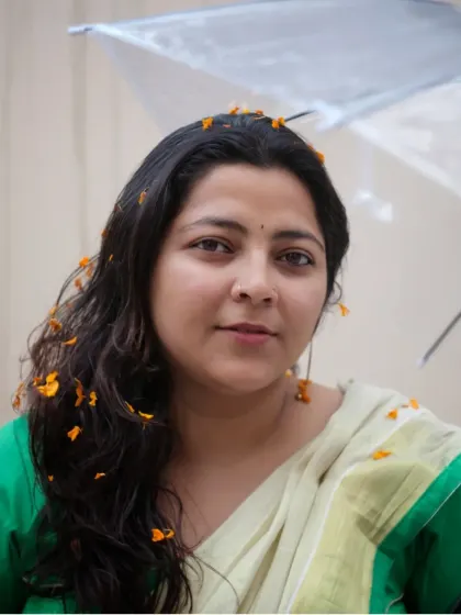 A self-portrait in a saree, with flower petals in my hair. I love blending traditional attire with playful, modern ideas.