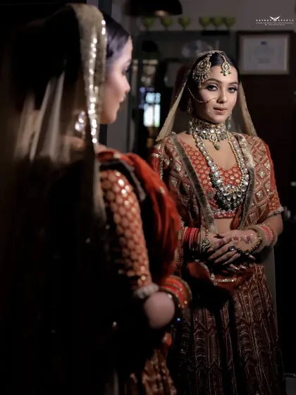 A full-length reflection shot, capturing the bride looking at herself in a mirror. This photo tells a story of the moments just before the main event, full of anticipation.