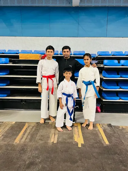 Me with three of my students at the South India tournament in Trivandrum. I am there to coach and support my athletes at every competition.