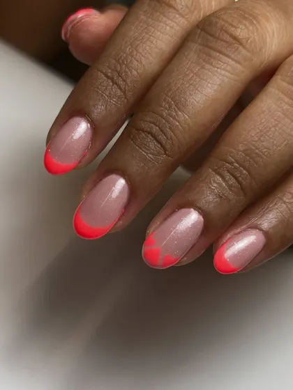 These tips are made to steal hearts. I updated the classic French with a fun twist by shaping the neon pink tips into little hearts.