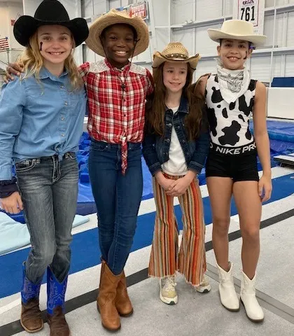 Howdy partners! Our gymnasts showing off their western wear for Rodeo Day during our team spirit week. These themed days are a fun way to build team camaraderie.