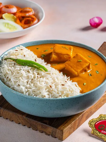 A delicious bowl of Shahi Paneer with jeera rice, perfect for a lunch menu feature.
