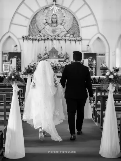 A powerful black and white shot of the couple walking down the aisle together, towards the altar and their future.