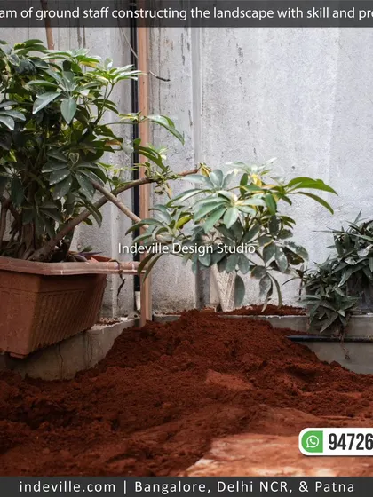 My team preparing the soil for a new planting bed. Proper soil preparation is the first and most important step in ensuring healthy plant growth.