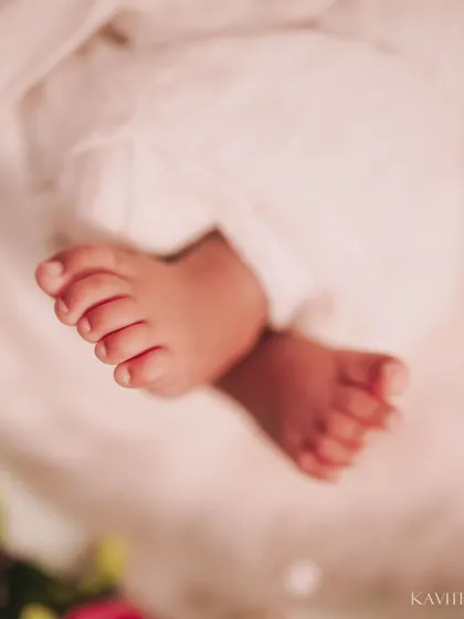 Tiny toes against a soft pink floral background. This macro shot is all about capturing the delicate and precious nature of a newborn's feet.