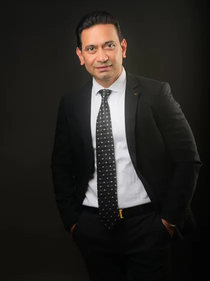 A relaxed yet professional standing portrait with hands in pockets. This pose feels natural and approachable.