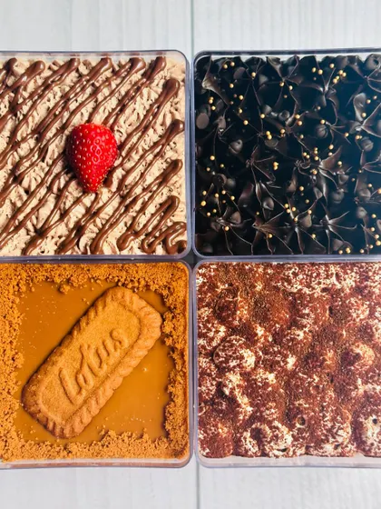 An overhead shot of the four assorted dessert tubs, showcasing the different toppings and textures of each flavor.