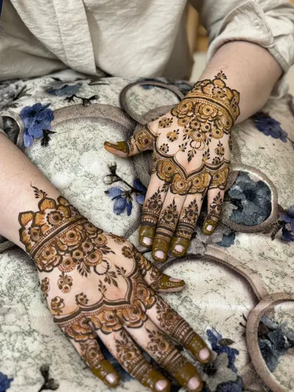 Both hands displayed, showing the symmetry and detail of the festive design.