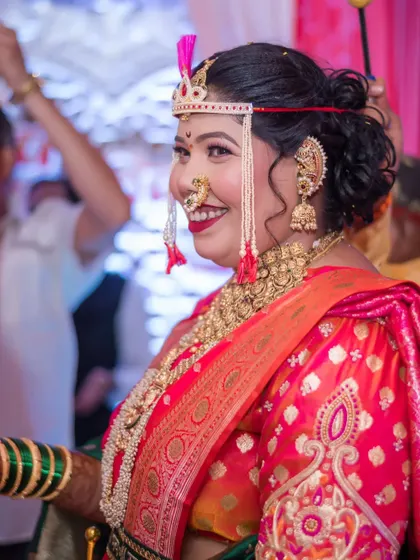 A candid side-profile shot of the bride, capturing her beautiful smile as she enjoys her wedding ceremony.