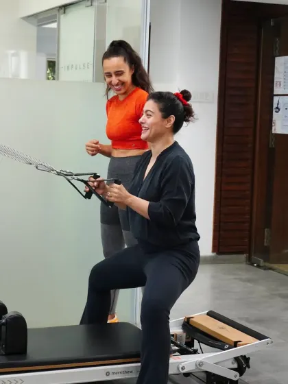 The joy of movement is at the heart of what we do. Kajol's smile says it all as she works her arms and core on the reformer, proving that getting stronger can be an enjoyable and rewarding process.