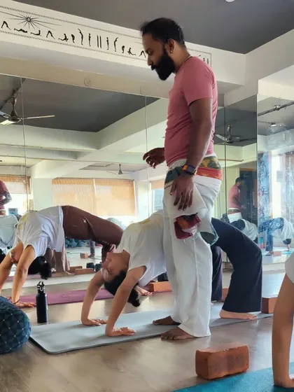 A behind-the-scenes look at our TTC, where our guru provides hands-on adjustments for Chakrasana (Wheel Pose). This personalized attention is crucial for safe and effective learning.