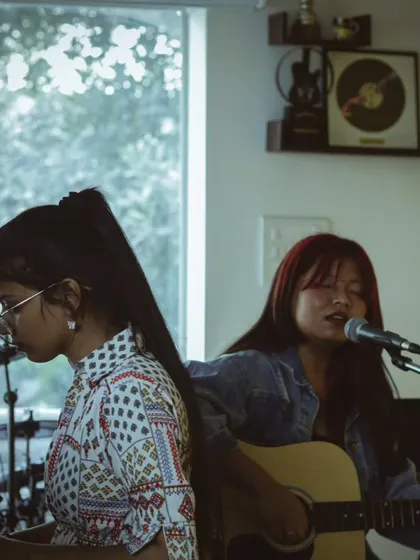 Two students, one on guitar and one on piano, performing together. We foster a collaborative environment where students can learn from and inspire each other.