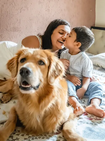 A happy family moment with a Golden Retriever photobombing his mom and little brother. These are the fun, candid shots that families love.