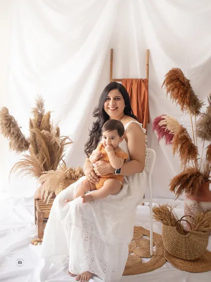 A mother and her baby in our earthy, boho studio setup. The natural textures and warm tones create a relaxed and stylish family portrait.