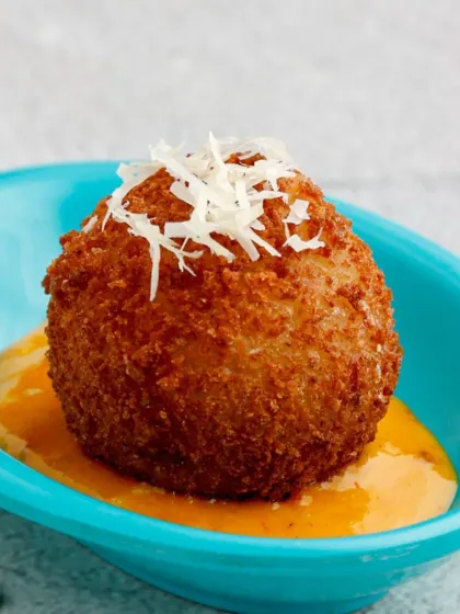 A close-up of our irresistible Potato Rellons Truffleadas. The perfectly golden-brown crust gives way to a soft, flavourful interior, making it a truly indulgent appetiser.