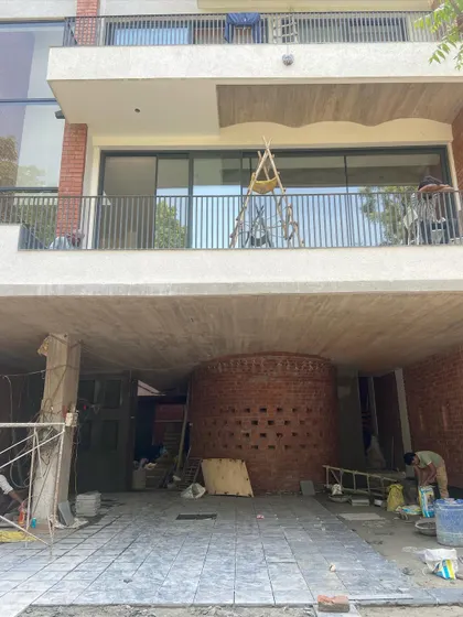 The ground floor of the Waterfall house under construction, showing the relationship between the parking area, the supportive columns, and the sculptural brick element.