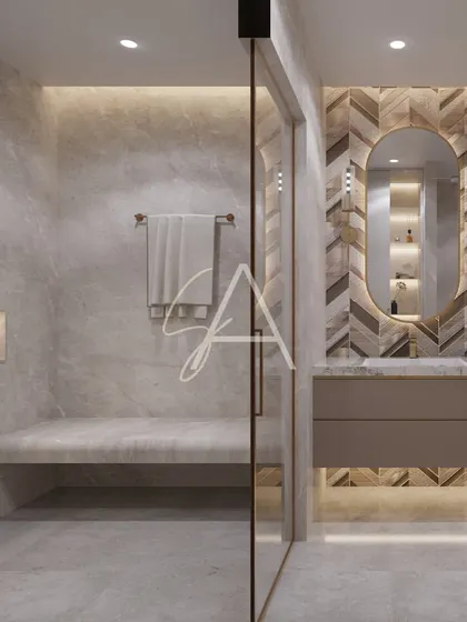 The walk-in shower features a built-in marble bench for a spa-like experience. The seamless glass partition keeps the space feeling open and modern, while the niche provides practical storage.