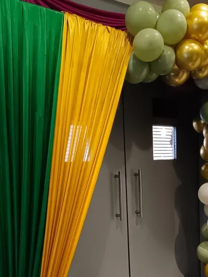 The entrance draping for an animal-themed party, using colors of green, yellow, and gold.