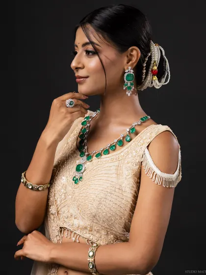 A profile shot of the model, highlighting her earrings and elegant posture.