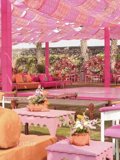 The lounge area featured colorful low seating, printed rugs, and a canopy of pink block-printed fabric, creating a relaxed and festive space for guests to mingle.