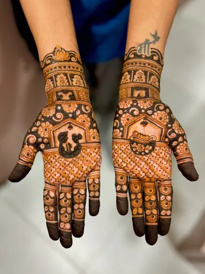 Kratika's mehendi featuring symbolic elements like a cradle and a swaddled baby, perfect for a baby shower or a new mom.