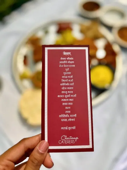 A personalized menu card in Marathi, detailing all the delicious dishes served in the traditional Pangat, adding a thoughtful and authentic touch to the experience.