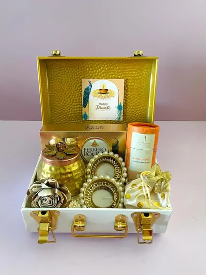 A stunning all-gold themed curation in our white metal trunk, featuring Ferrero Rocher, a decorative jar, and pearl t-light holders.