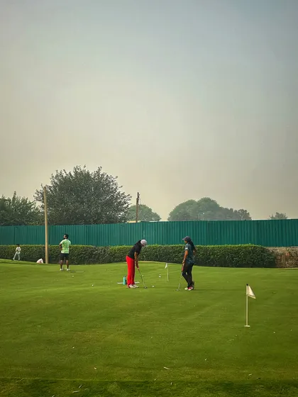 Two women practice on the putting green, enjoying a weekend session together.