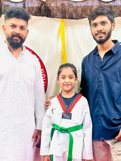 Another proud student with her new green belt.