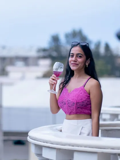 A guest enjoying a drink on one of the mansion's balconies. These private outdoor nooks offer a lovely escape and a beautiful view for more intimate moments.