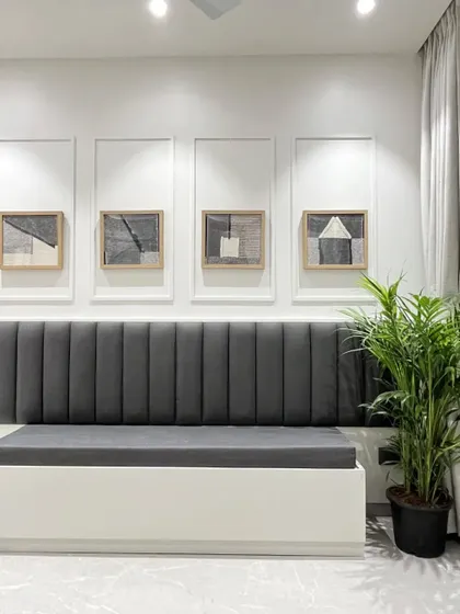 A full view of the dining bench, showing the abstract art framed by simple wall molding.