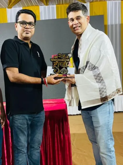 Receiving a token of appreciation for hosting a Ganesh Utsav celebration. It's always a pleasure to be part of community festivities.