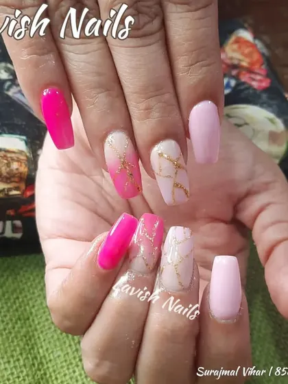 A vibrant pink set with accent nails showcasing a pink and white marble effect with delicate gold veining.